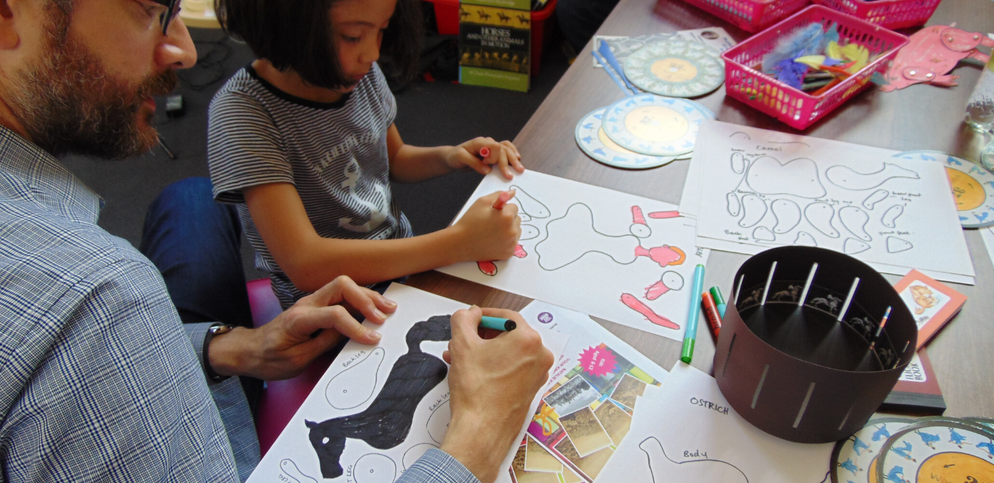 A parent and child doing some colouring