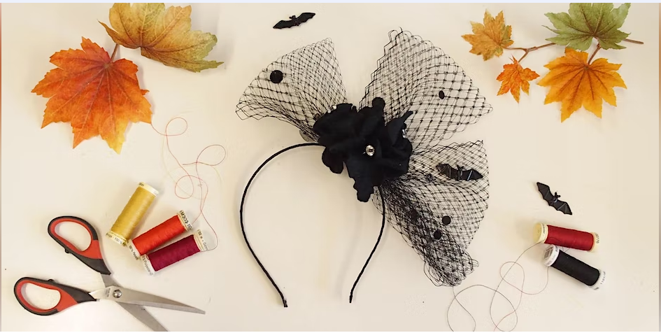 Halloween style headband and scissors on a table decorated with leaves