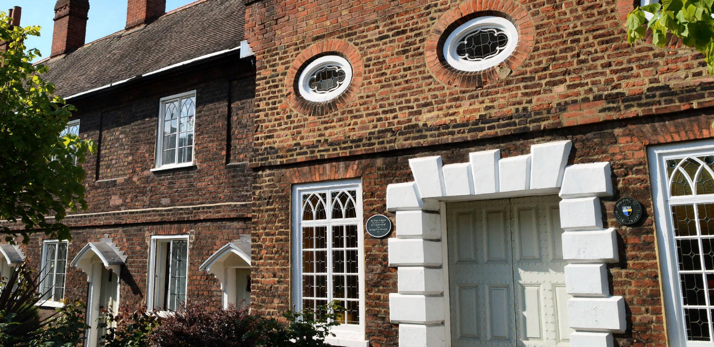 The brick exterior of Cleaves Almshouses