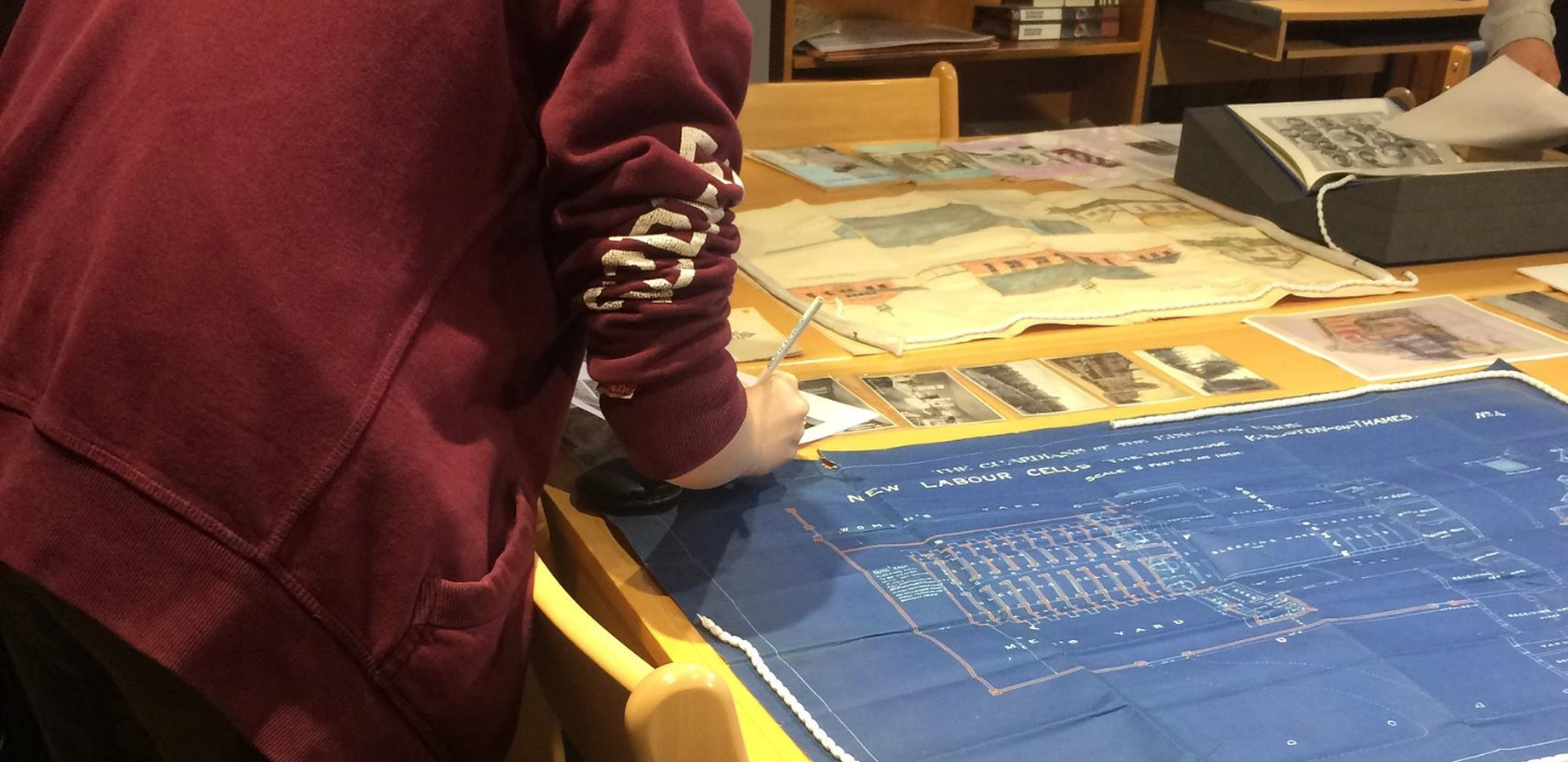 Someone reviewing old records such as maps at Kingston History Centre