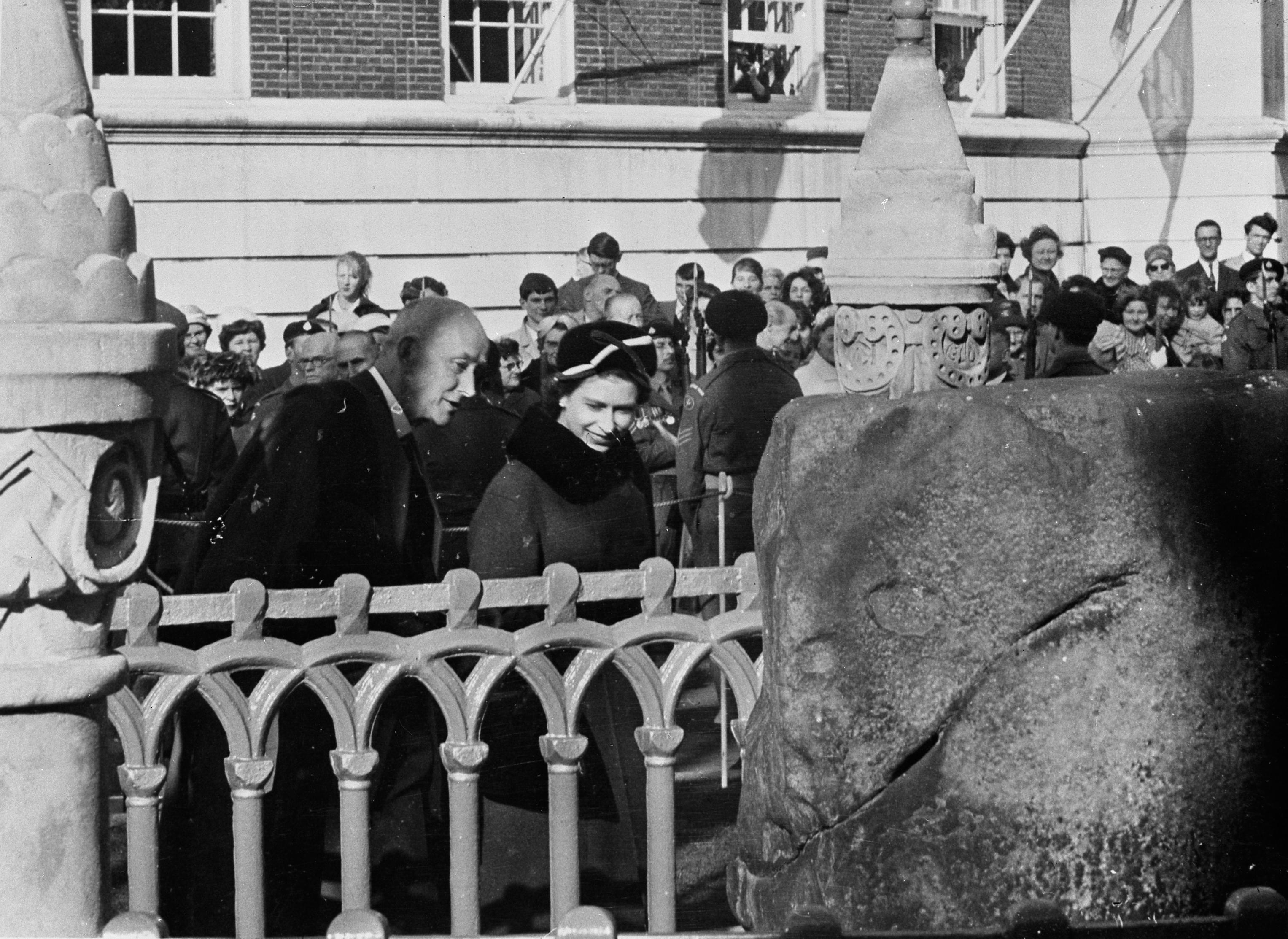 The Queen at the Coronation Stone during her visit to Kingston for the 400th anniversary of Kingston Grammar School