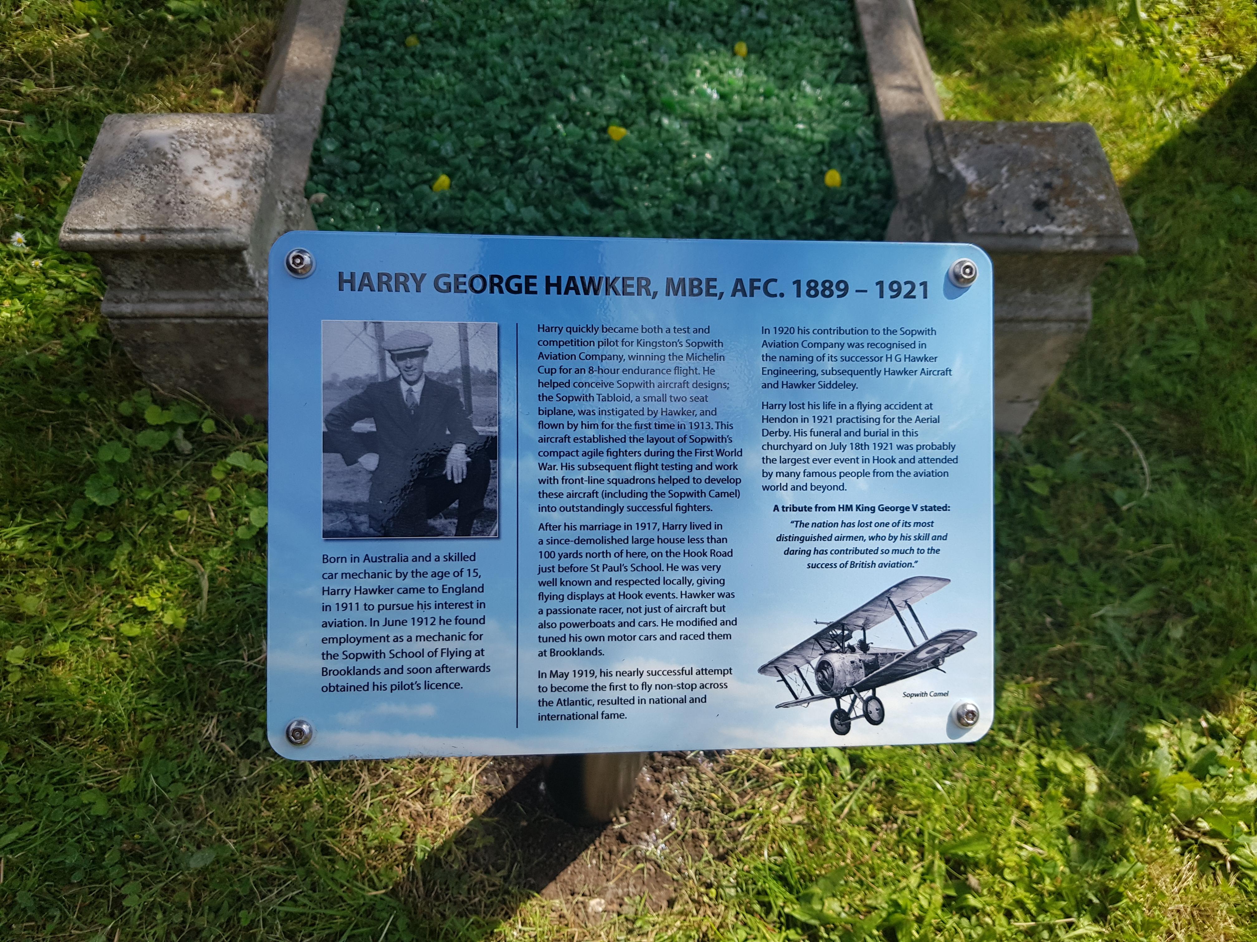 A sign at the grave of Harry Hawker MBE, with information on his life.