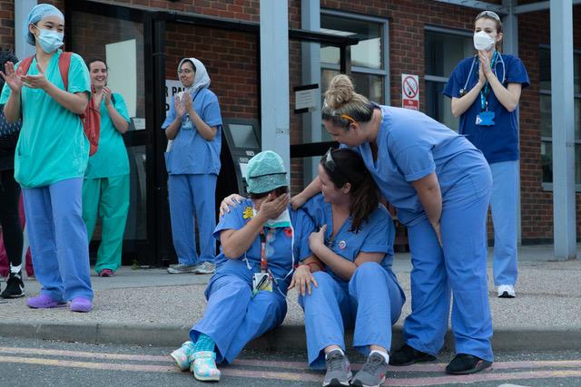 Yoshi Bunce Kawajigashi Alvarado breaks down in tears outside the entrance to Kingston hospital as frontline staff including doctors, nurses, patients and RAC staff clap for carers, key workers and NHS staff at the peak of the pandemic lockdown.