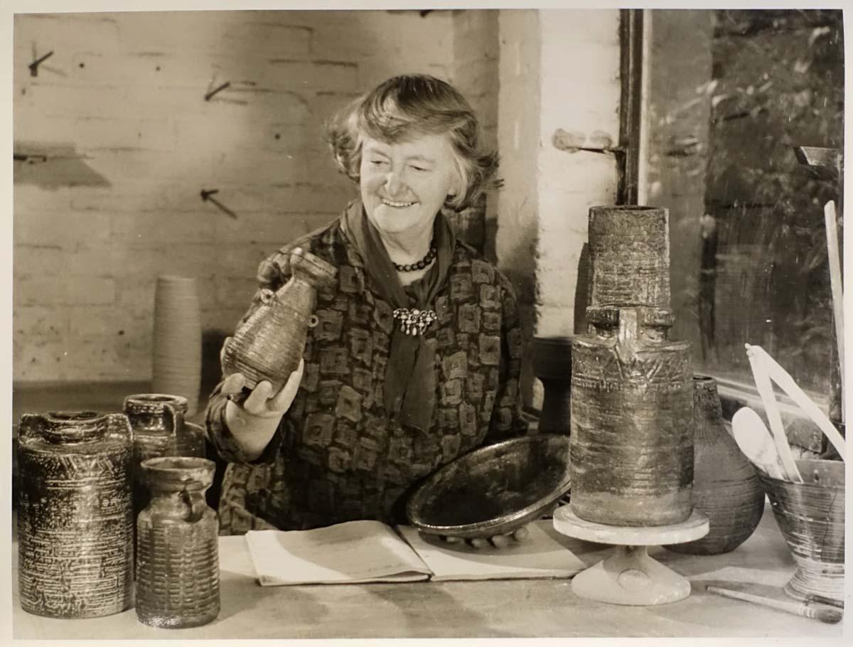 Denise Wren at Oxshott in 1968 with her saltglazed stoneware pots from the Commonwealth Institute Exhibition of 1967.