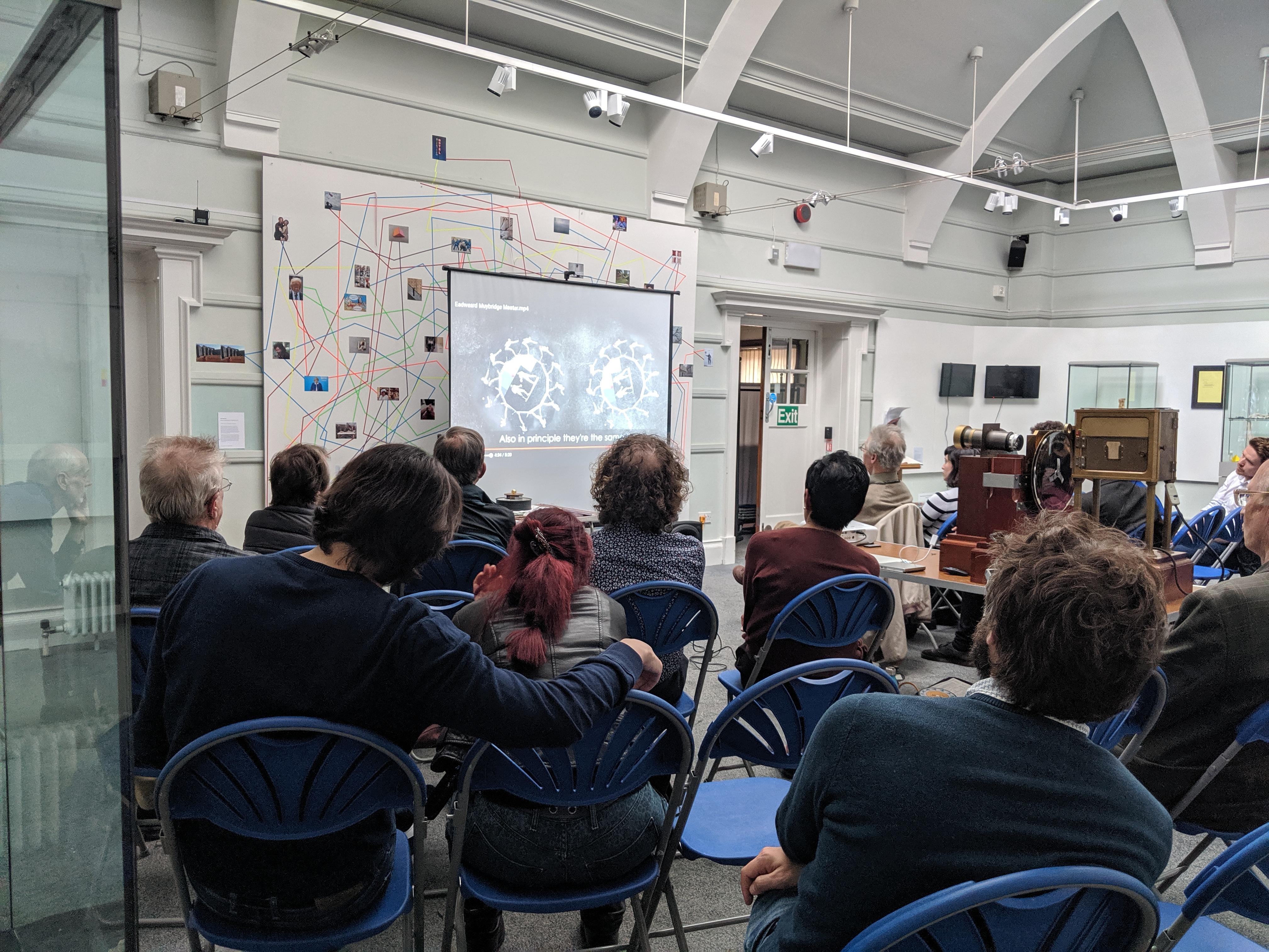 A group of people sat listening to a talk in Kingston Museum