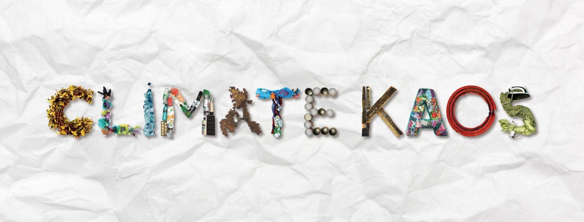 &#039;Climate KAOS&#039; spelt out with recycled waste items such as fabrics, plastic bottles etc.
