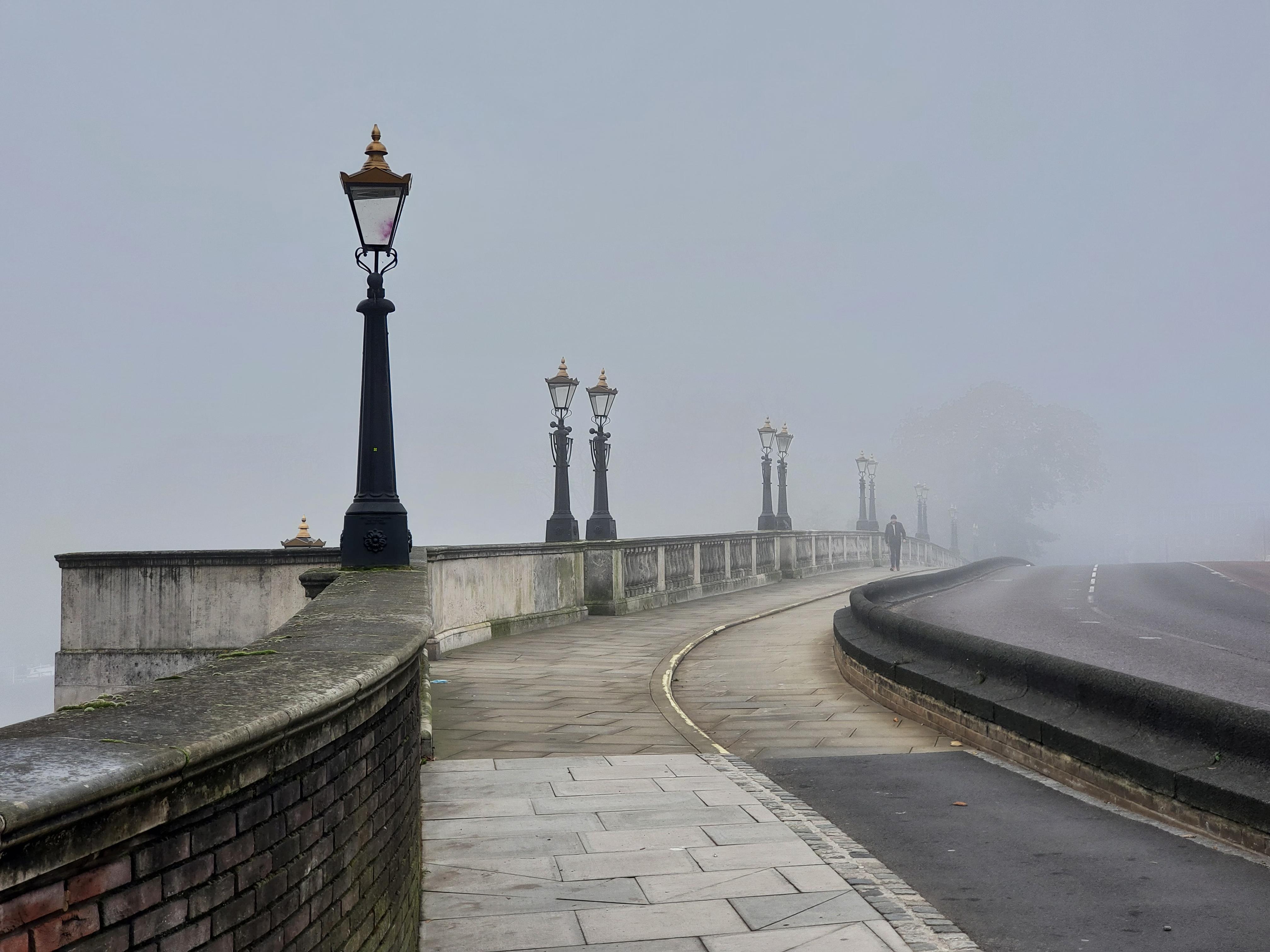 The early morning view over Kingston Bridge from the direction of Market place. The bridge is empty and covered in a thick, grey fog.