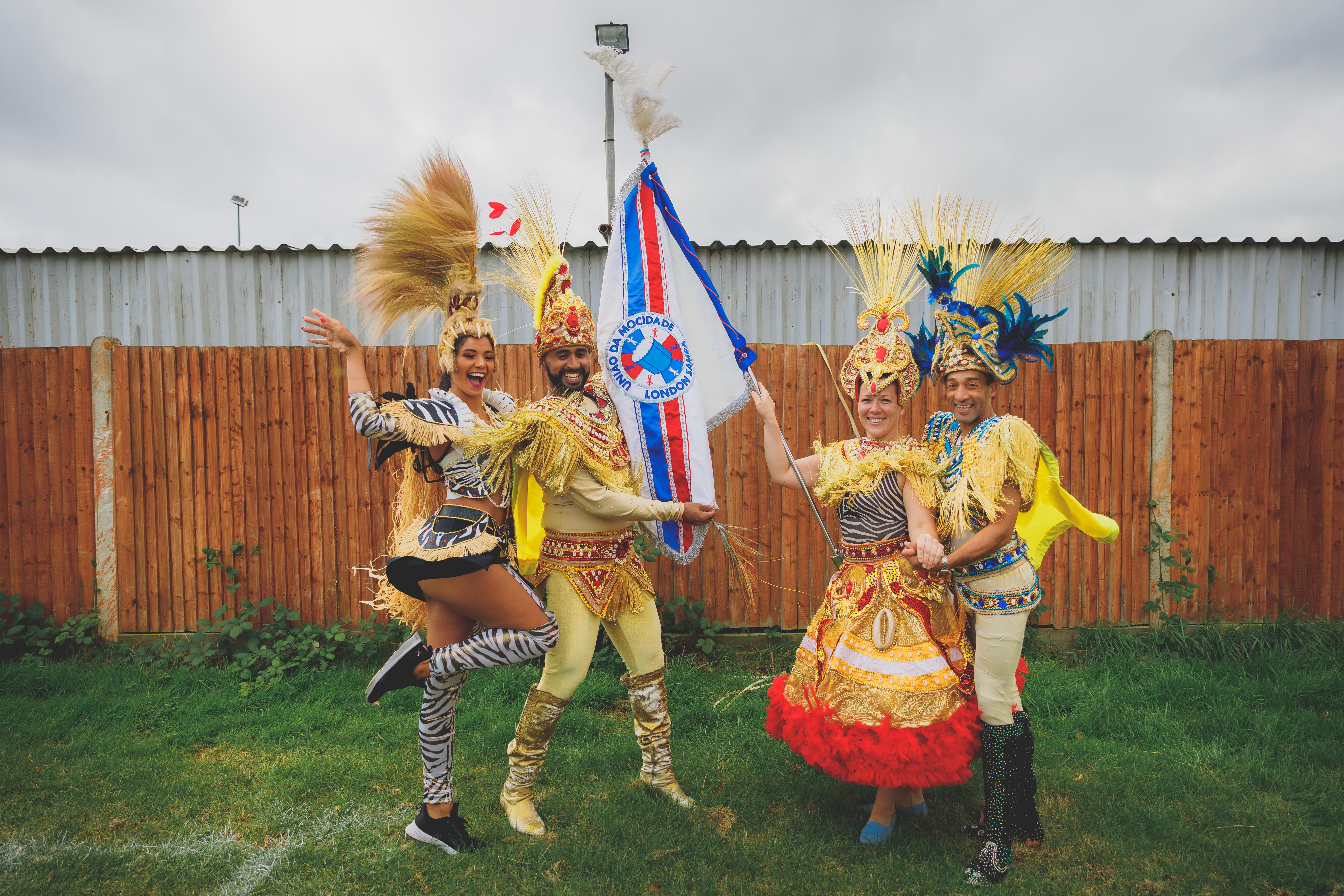 People in carnival style dress at Vai Tolworth Brazil Festival.