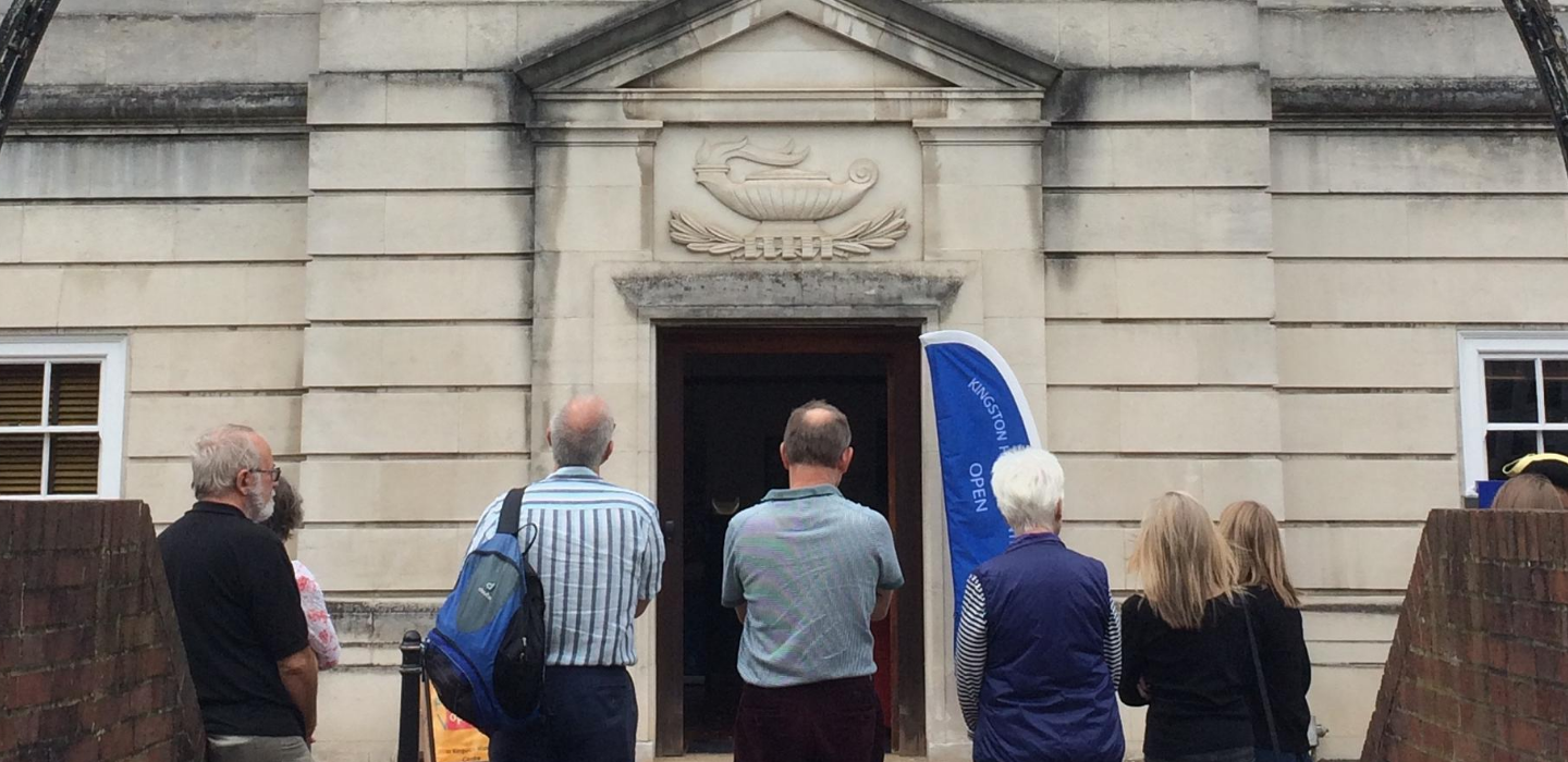 People stood outside Kingston History Centre looking at the door