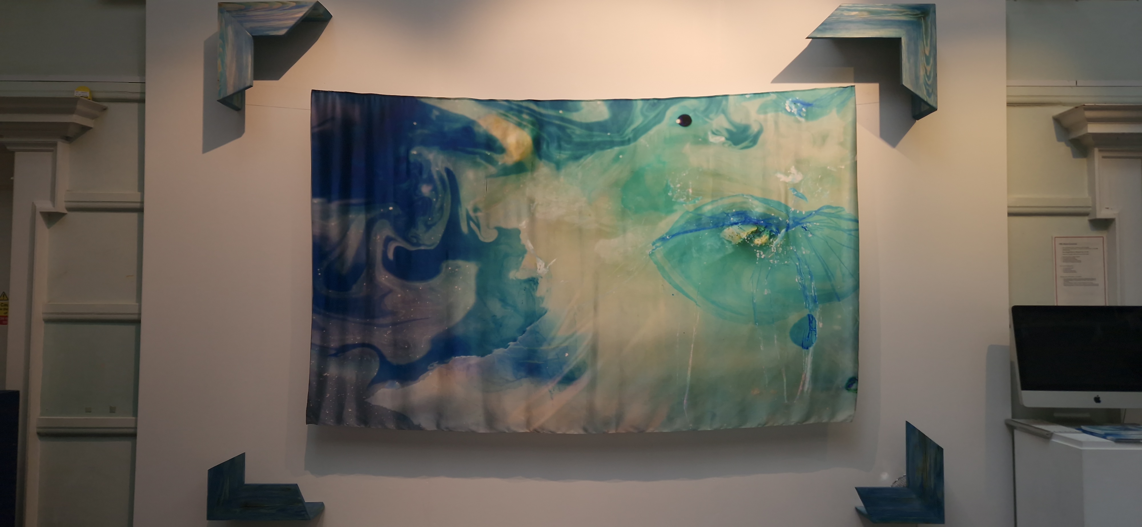 A fine art work by Lynsday Russell hangs on a wall in the exhibition